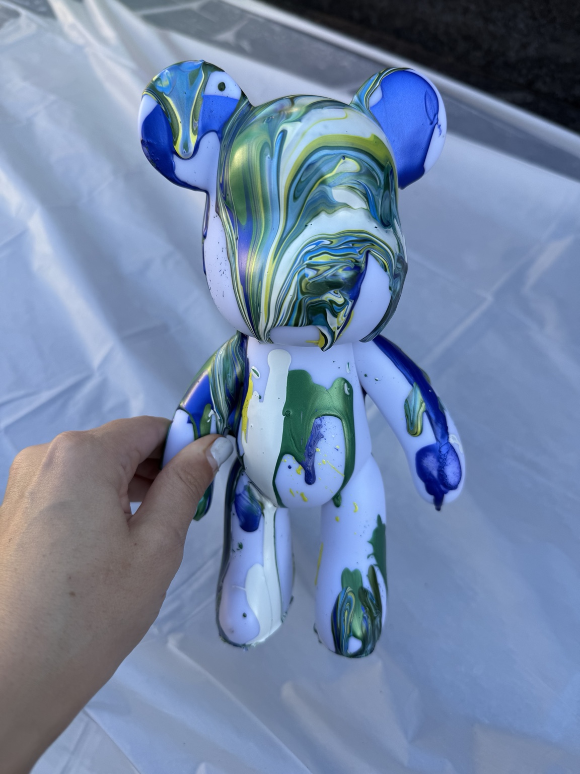 White bear with blue and green paint